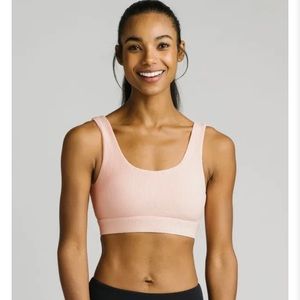 Zyia brand NEW sports bra, size large, color pinstripe peach color.